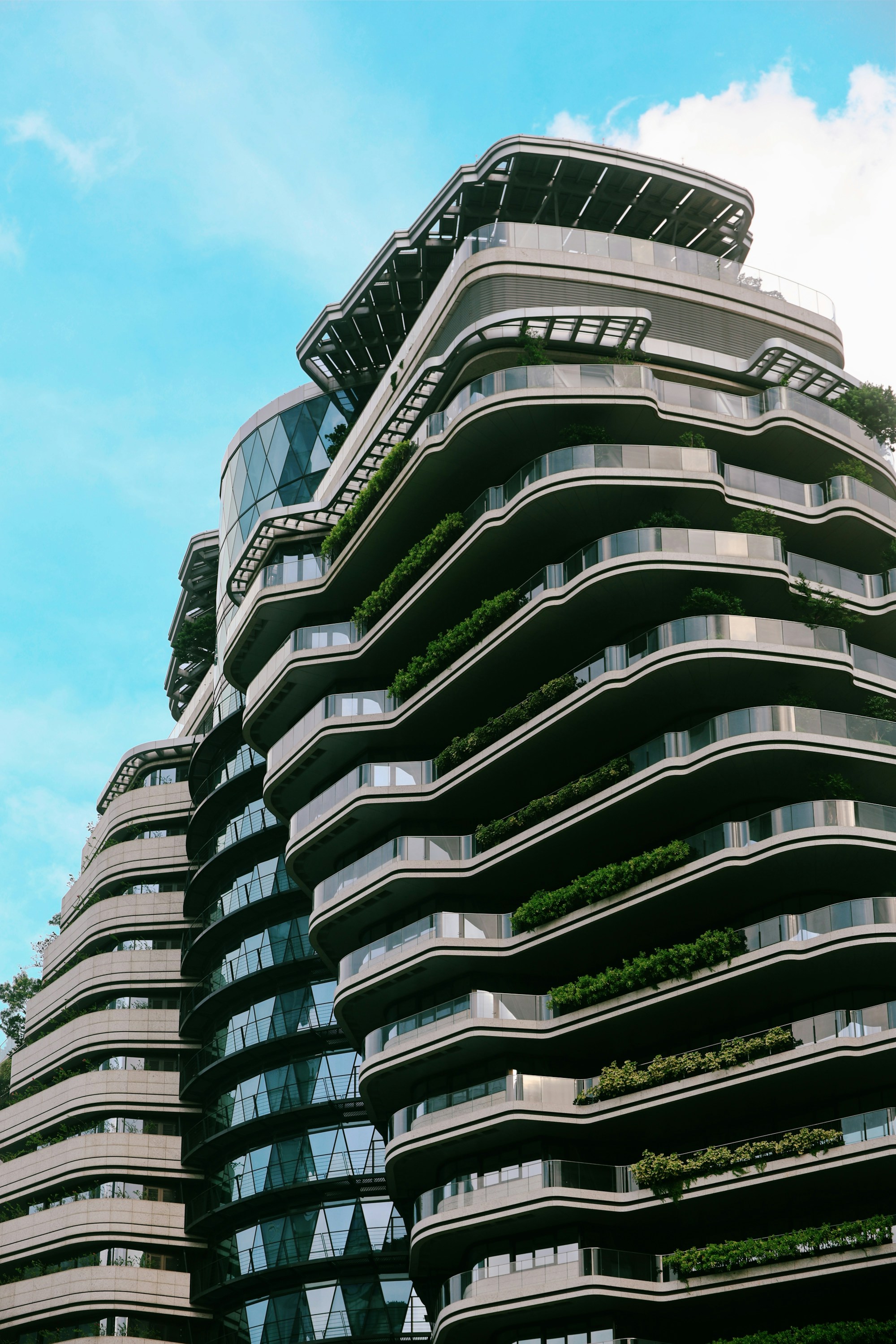 Contemporary apartment architecture with curved balconies and greenery